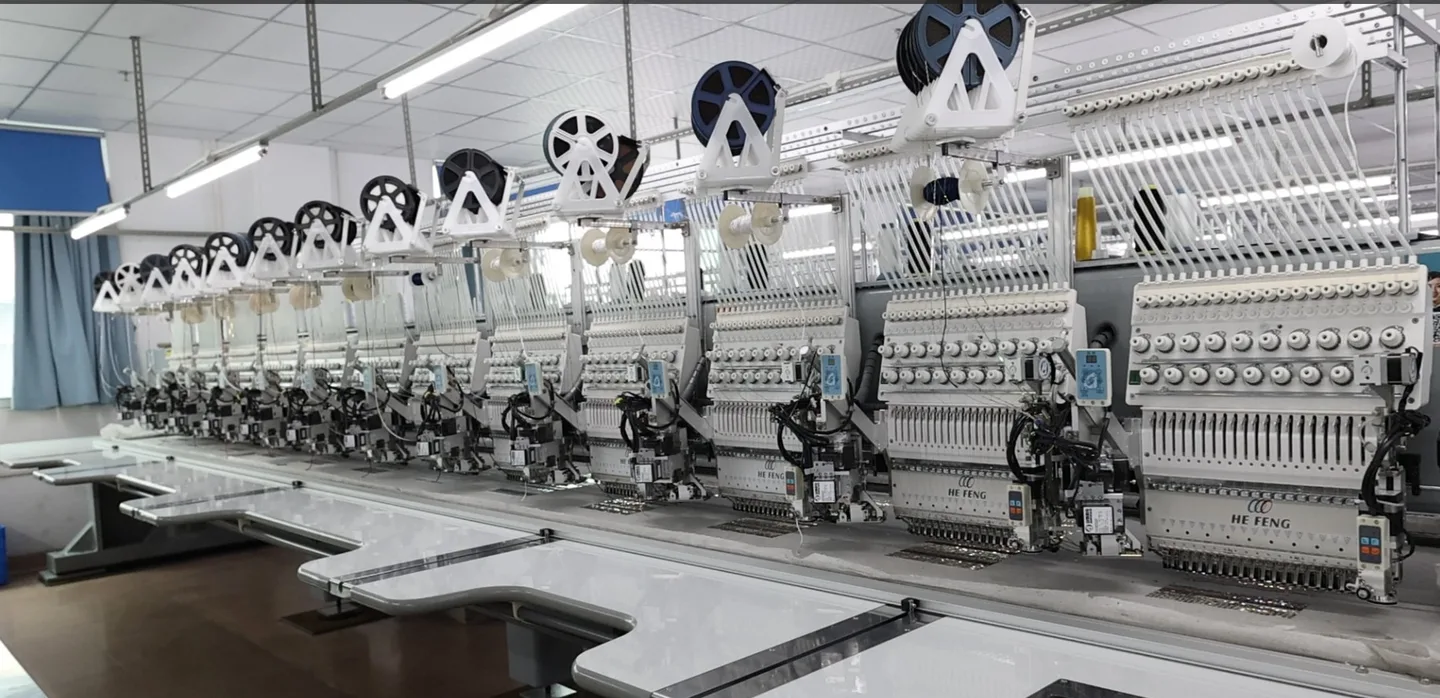 Long row of HE FENG specialty embroidery machines on the in-house line